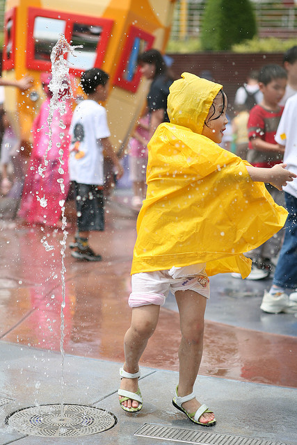 child in raincoat in the rain
